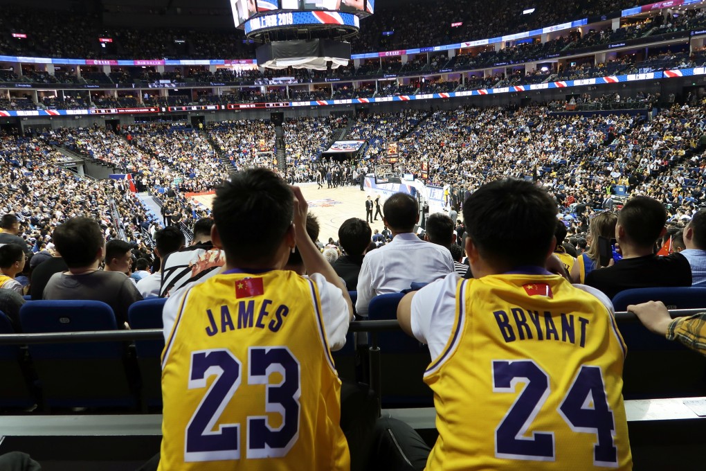 Chinese basketball fans wearing the Los Angeles Lakers jerseys of LeBron James and Kobe Bryant watch the Lakers play the Brooklyn Nets in Shanghai in October, 2019. Photo: Reuters