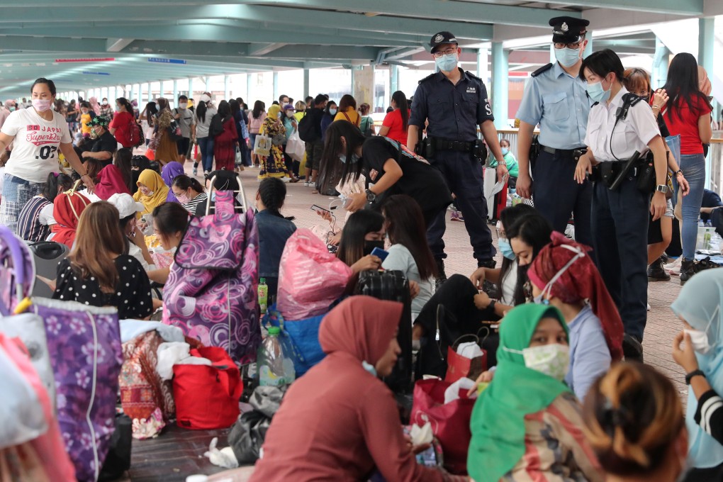 Domestic helpers on a footbridge in Mong Kok on their day off earlier this month. Photo: Edmond So