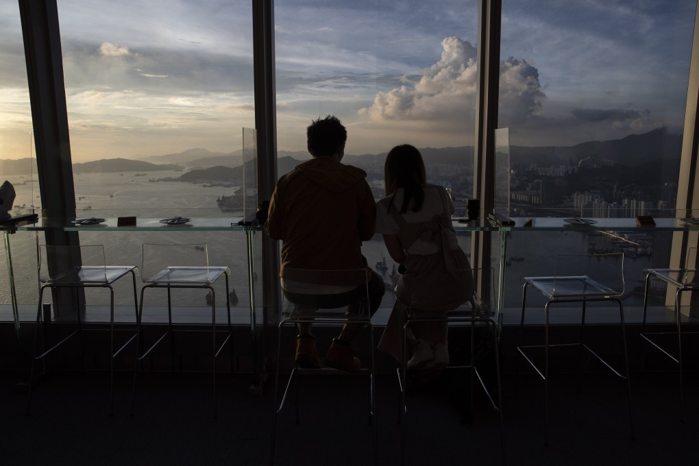 A couple sitting in a cafe looks out over the Hong Kong skyline on September 20. Photo: AFP