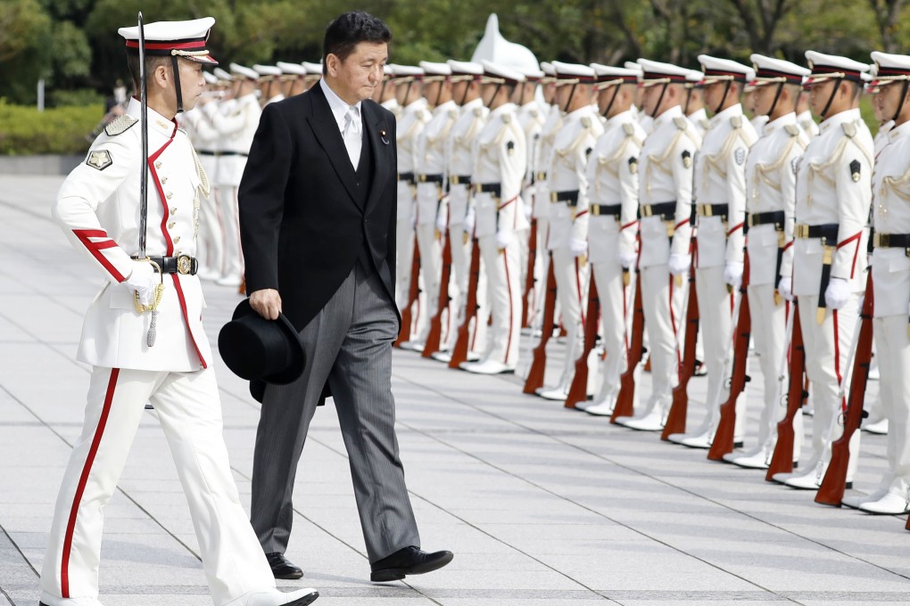 Japan‘s defence minister, Nobuo Kishi, receives a guard of honour during a ceremony in Tokyo a day after he took up the post. Photo: Kyodo