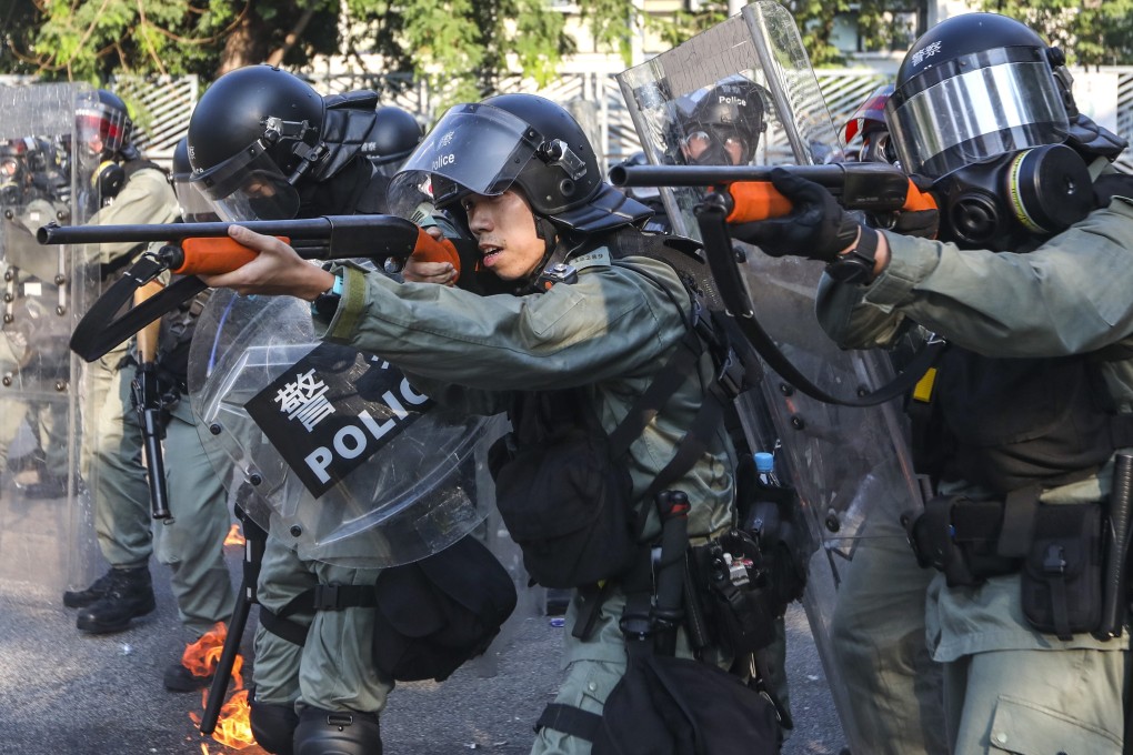 Riot police with shotguns form a defensive line in Tuen Mun during a mass rally on October 1 last year. Photo: Xiaomei Chen