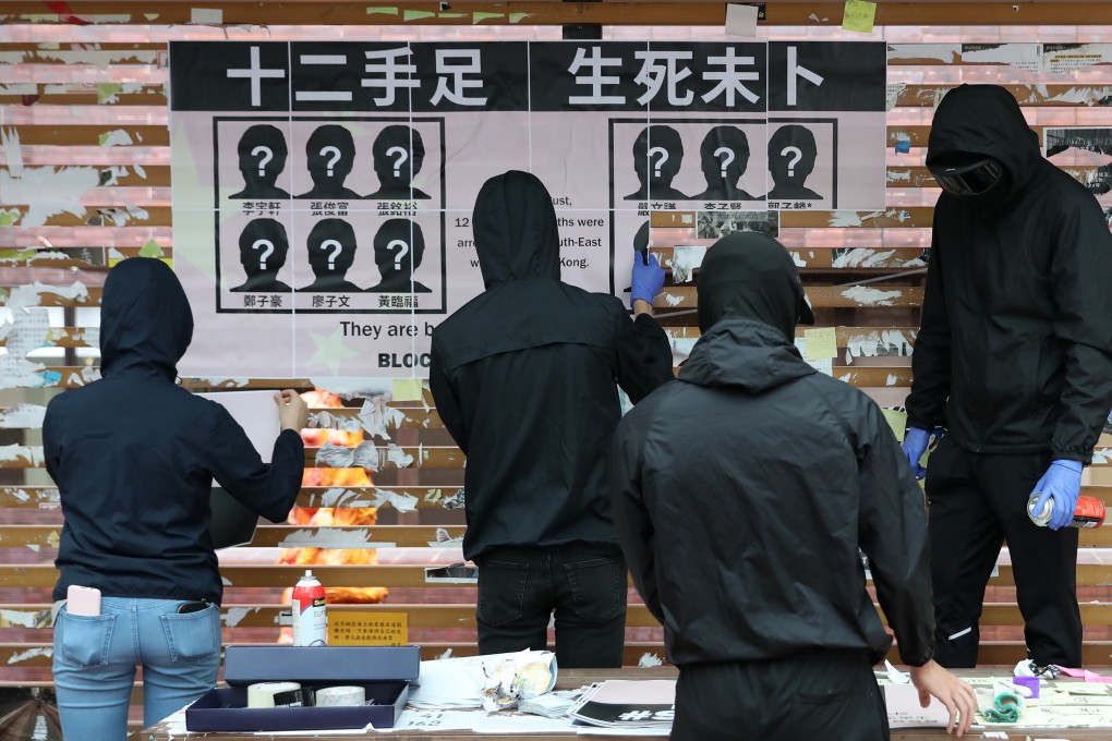 Activists rebuild a Lennon Wall that was targeted on a University Hong Kong campus. Photo: Nora Tam