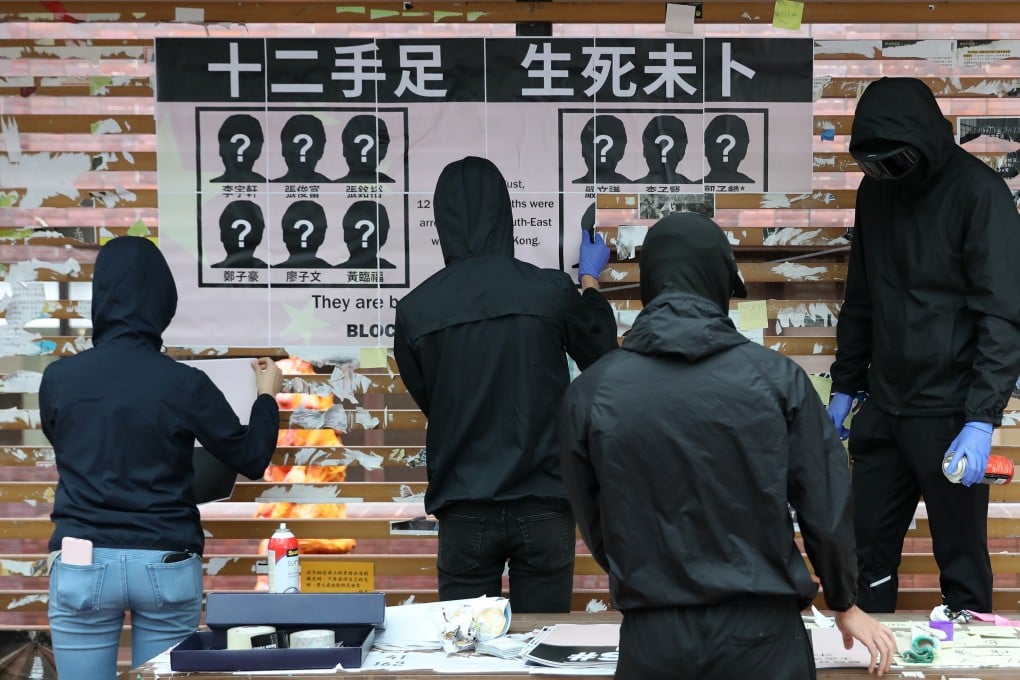 Activists rebuild a Lennon Wall that was targeted on a University Hong Kong campus. Photo: Nora Tam