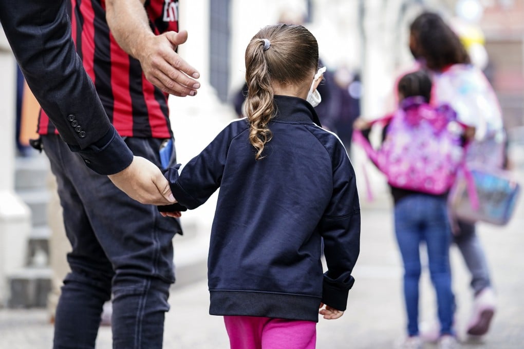 Students arrive for in-person classes outside a school in New York on Tuesday. Photo: AP