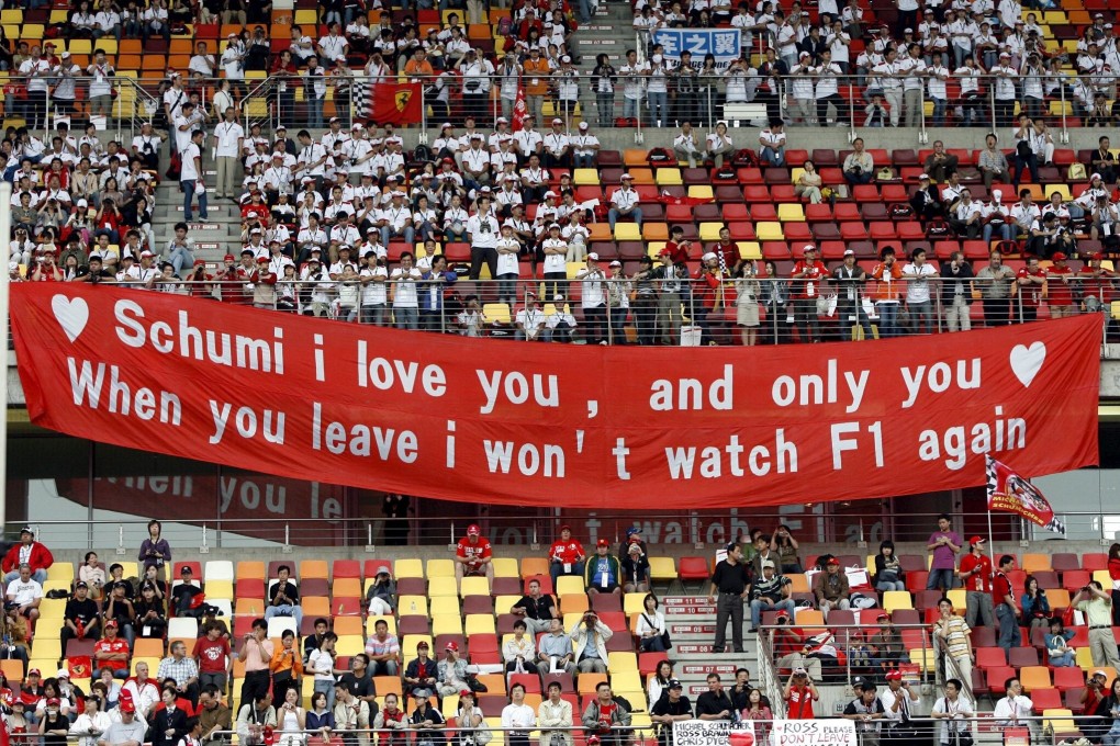 Chinese F1 fans hold a banner supporting Ferrari driver Michael Schumacher at the third practice session of the 2006 China Grand Prix. Photo: EPA