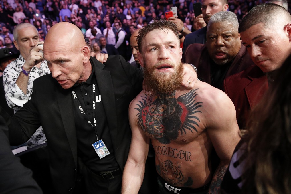 Conor McGregor is escorted from the Octagon after fighting Khabib Nurmagomedov in a lightweight title bout at UFC 229. Photo: AP