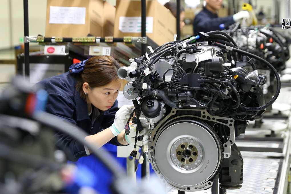 Workers build car engines at a factory in Mianyang, Sichuan province. Photo: Reuters