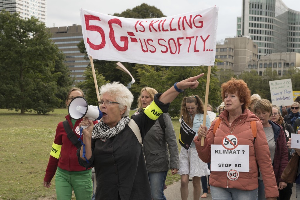 Protesters march against 5G technology in The Hague, Netherlands. They are worried about possible side effects from prolonged exposure to high frequency radio waves. Photo: Michel Porro/Getty Images