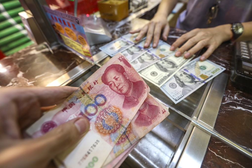 US dollar banknotes and Chinese 100 yuan banknotes at a money exchange shop in Causeway Bay on 5 August 2019. Photo: Roy Issa