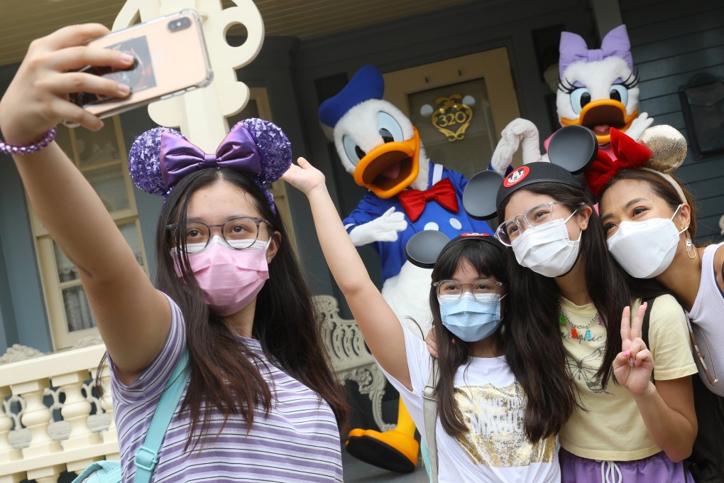 Visitors pose for a socially distanced selfie with Disney characters in Hong Kong Disneyland on September 25. Photo: Dickson Lee