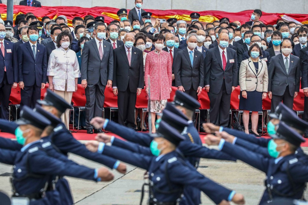 Chief Executive Carrie Lam, and senior officials and guests view ceremonies marking the 71st anniversary of the People’s Republic of China, at the Golden Bauhinia Square in Wan Chai on October 1. The square and the nearby area were designated as a restricted zone by police, and there was no public viewing area for the flag-raising on account of the coronavirus health risk. Photo: Nora Tam
