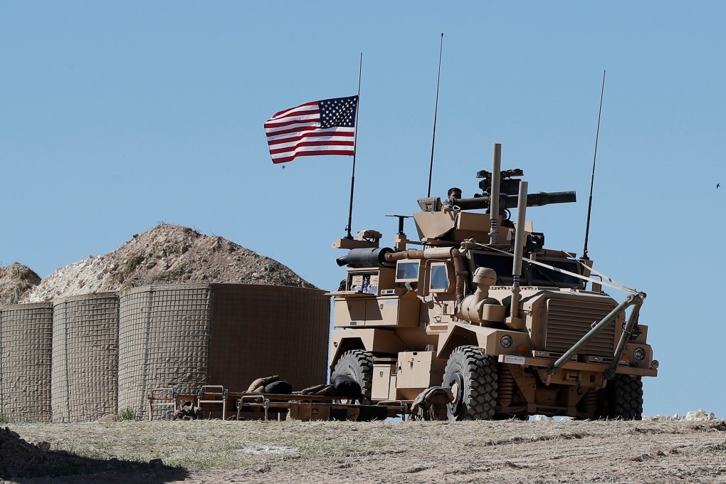 A US soldier sits on an armoured vehicle near the tense front line between the US-backed Syrian Manbij Military Council and the Turkish-backed fighters, in Manbij, north Syria. Photo: AP