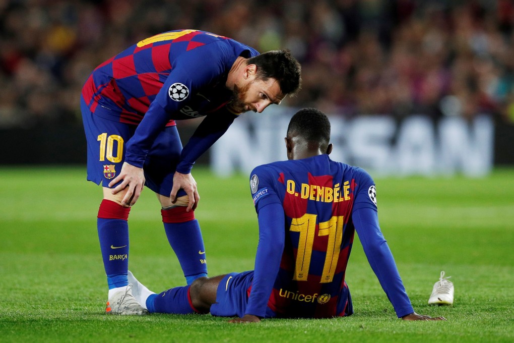 Barcelona’s Lionel Messi talks to Ousmane Dembele as he is down injured in a Champions League game against Borussia Dortmund in 2019. Photo: Reuters