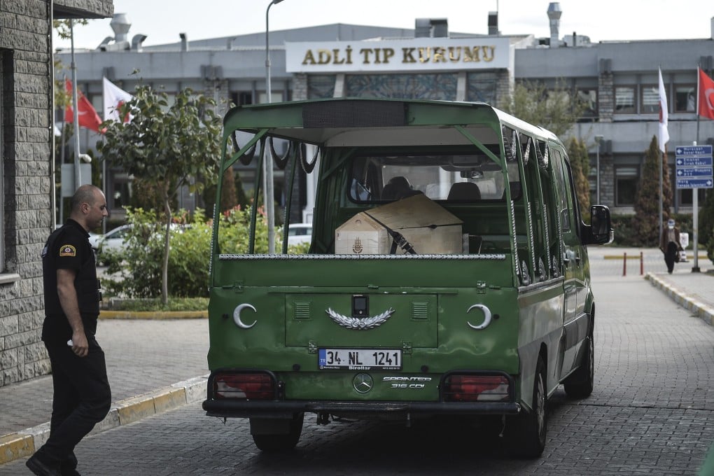 A hearse carrying the coffin of American journalist and author Andre Vltchek is driven into the forensic medicine institution building for an examination in Istanbul. Photo: AP