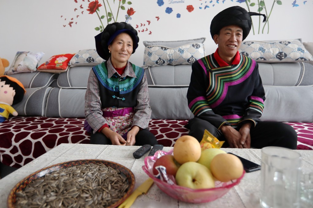 Jifu Jifuzi and his wife Li Youling watch TV in their new home. Photo: Simon Song