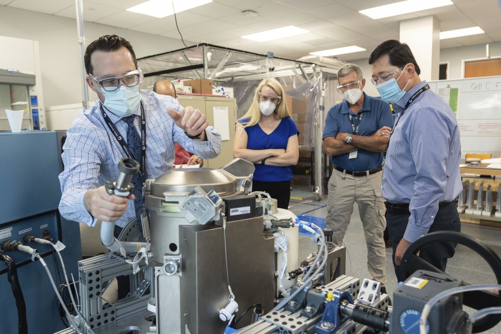 Astronaut Kate Rubins (centre) and support personnel review the Universal Waste Management System, a low-gravity space toilet, in Houston in June. Photo: Nasa via AP