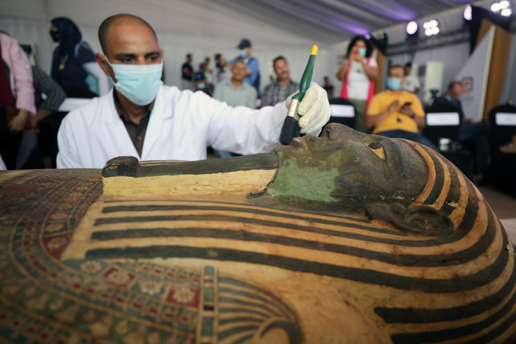 Egyptian archaeologists work on one of the sarcophagi discovered at Saqqara Necropolis in Giza, Egypt. Photo: EPA-EFE