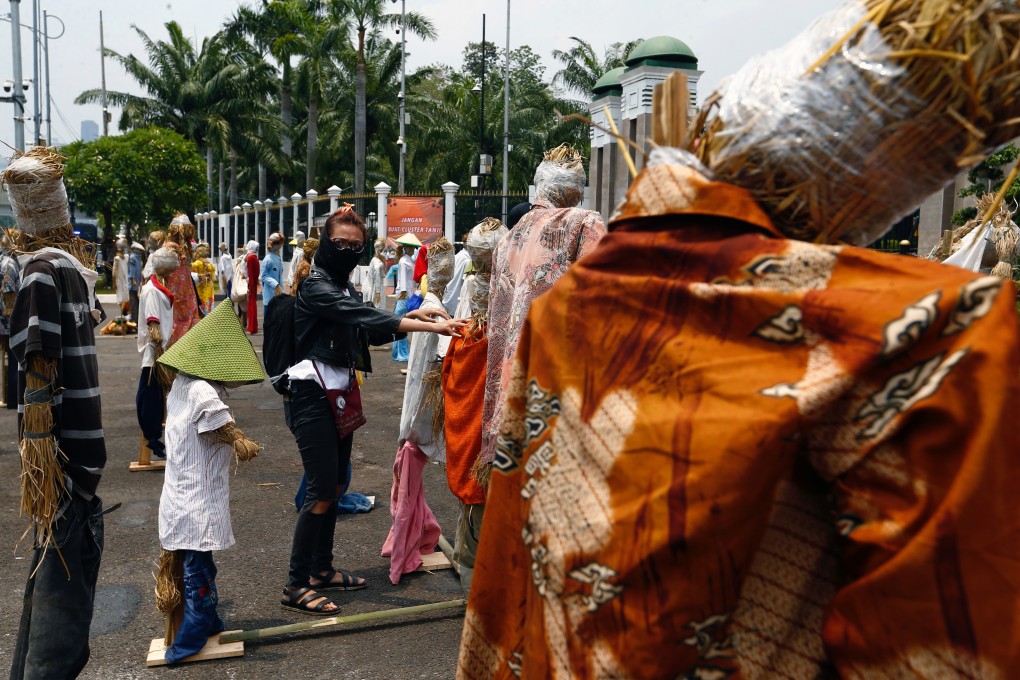A demonstrator sets up scarecrows for keeping social distancing during a protest outside the Indonesian parliament against the Omnibus bill in Jakarta last month. Photo: Reuters