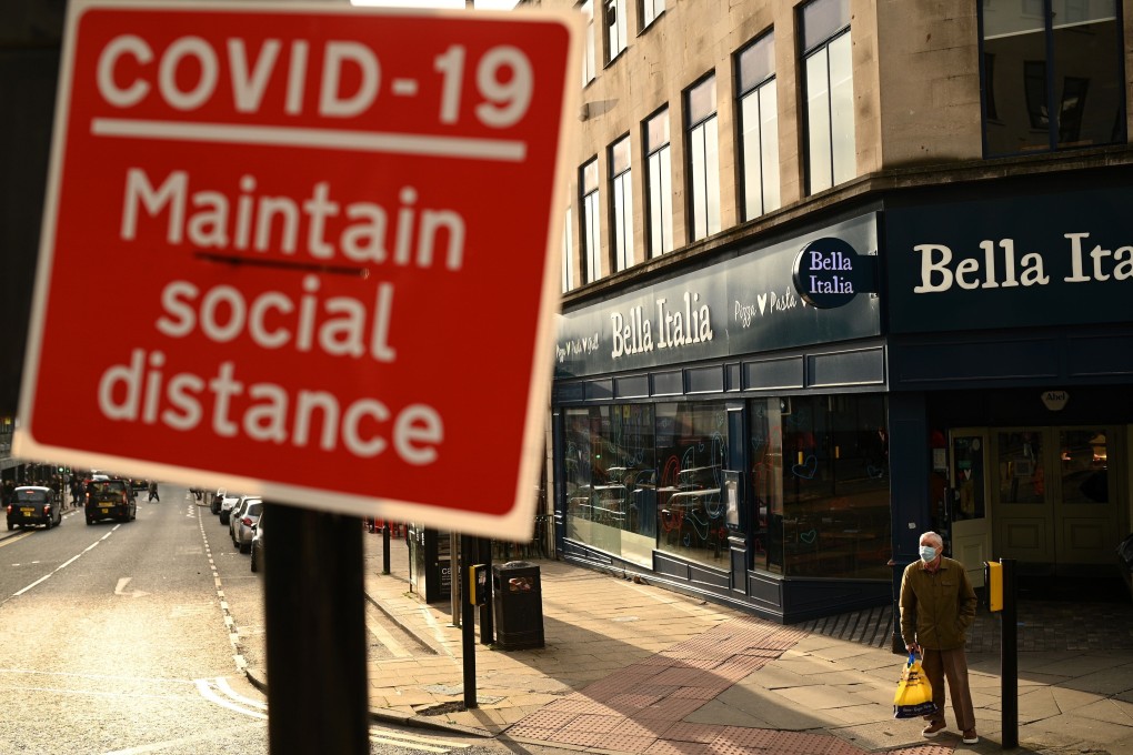 A sign near a pedestrian crossing alerts people to the need for social distancing in Liverpool, England on October 2. The UK has been designated a high-risk country by the Hong Kong government. Photo: AFP