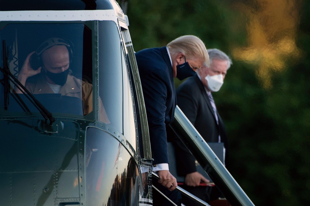 White House Chief of Staff Mark Meadows (right) watches as US President Donald Trump walks off Marine One while arriving at Walter Reed Medical Centre in Bethesda, Maryland, on October 2, after testing positive for Covid-19. Photo: AFP