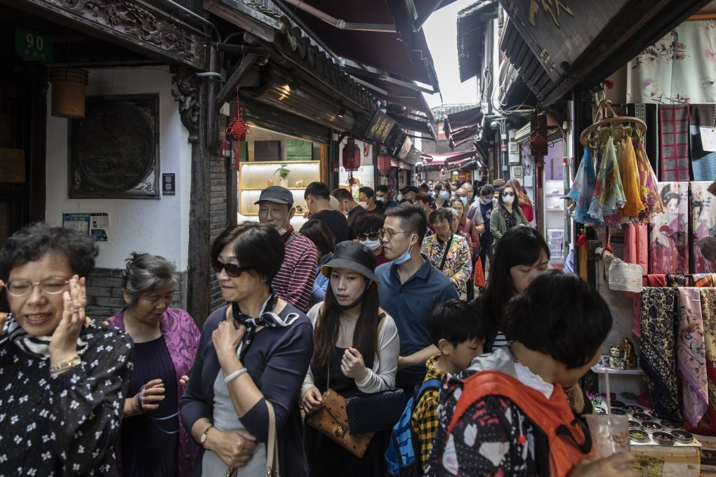 Visitors crowd onto a narrow alley in Zhujiajiao Water Town on the outskirts of Shanghai. Photo: Bloomberg