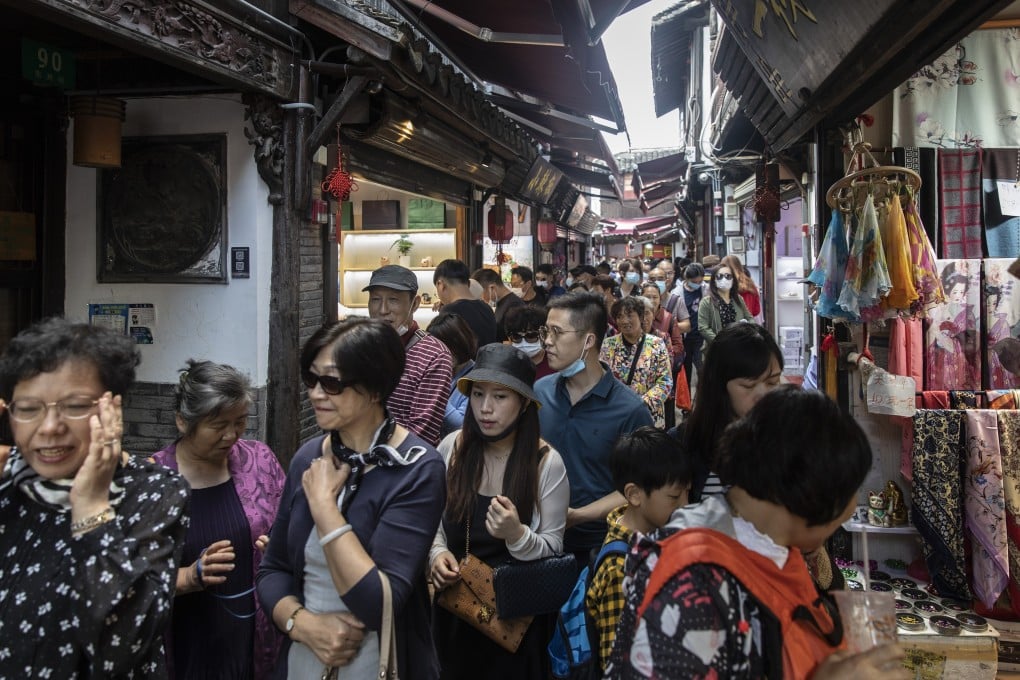 Visitors crowd onto a narrow alley in Zhujiajiao Water Town on the outskirts of Shanghai. Photo: Bloomberg