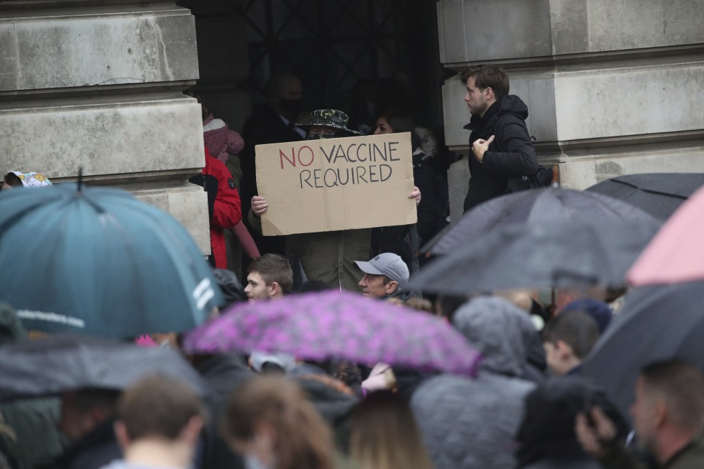 A protester holds a sign at an anti coronavirus lockdown protest in Nottingham, England, after new restrictions to combat the rise in coronavirus cases came into place in England on Saturday. Photo: PA via AP