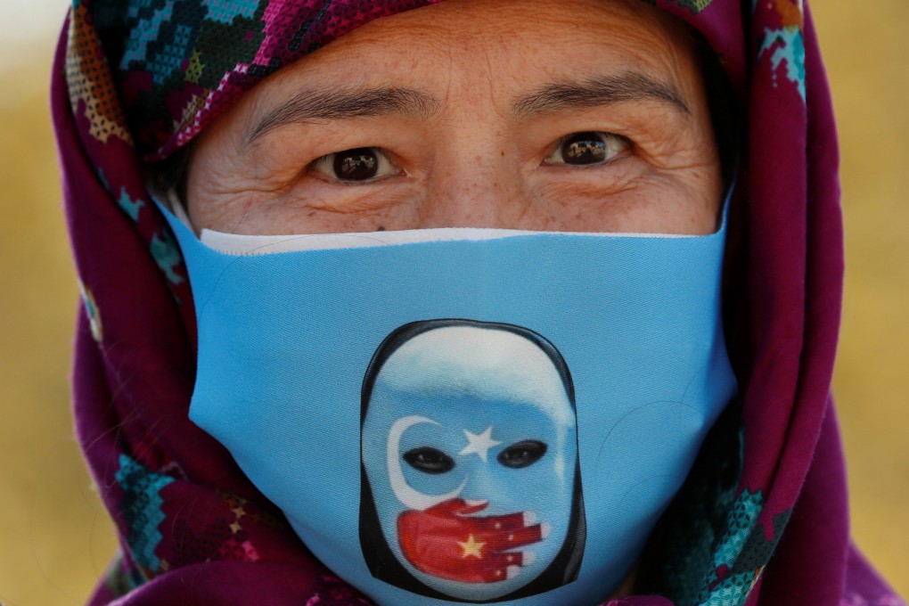 An ethnic Uygur demonstrator wearing a protective face mask takes part in a protest against China, in Istanbul, Turkey on Thursday. Photo: Reuters