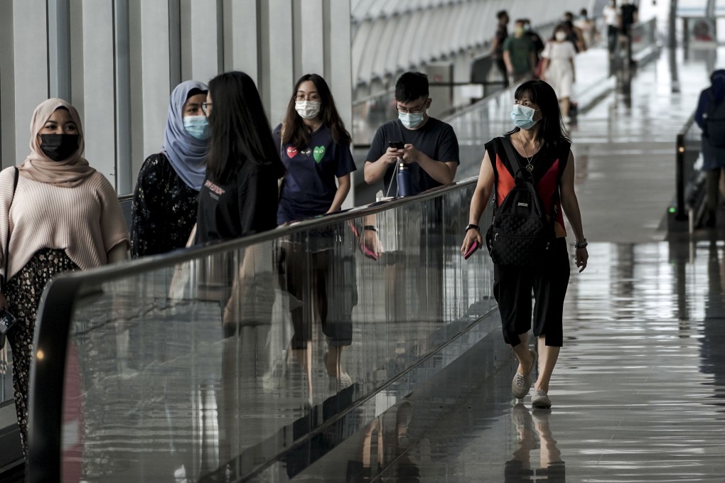 Travellers at Singapore’s Changi Airport, which has been servicing only a fraction of its usual traffic due to the coronavirus pandemic. Photo: EPA