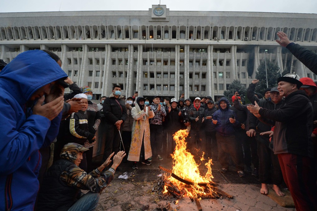 People protesting the results of a parliamentary vote gather by a bonfire in front of the seized main government building, known as the White House, in Bishkek, Kyrgyzstan, on October 6. Photo: AFP