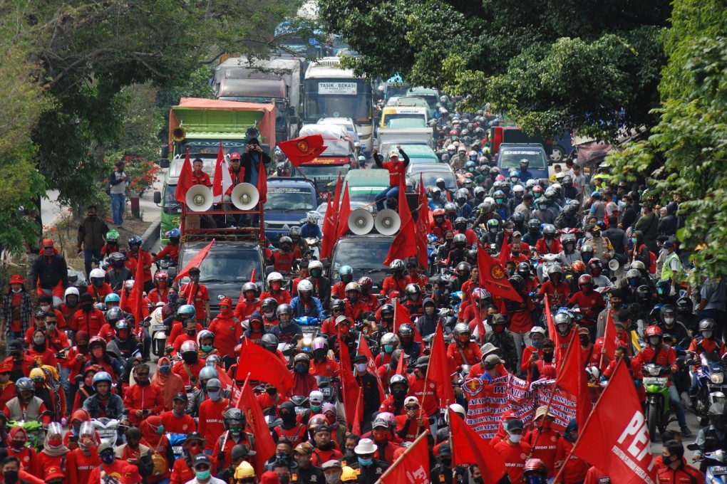 Workers in Bandung block a road during a strike against the newly enacted Omnibus Law. Photo: AFP