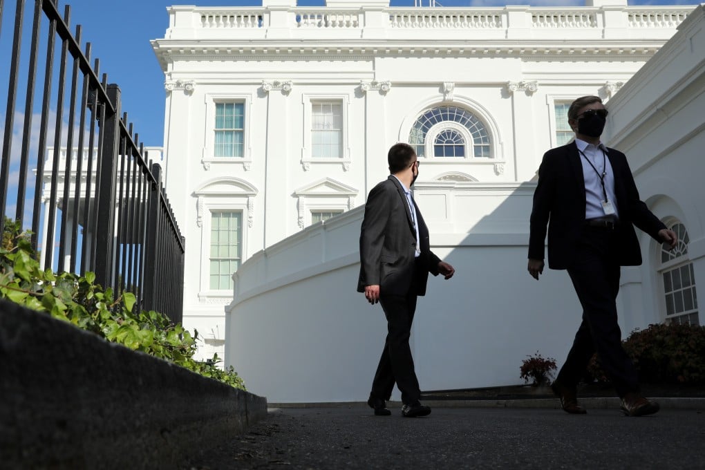 White House staff members walk from the residence toward the West Wing on Tuesday, the day after US President Donald Trump returned after being hospitalised with Covid-19. Multiple workers at the White House have also tested positive. Photo: Reuters
