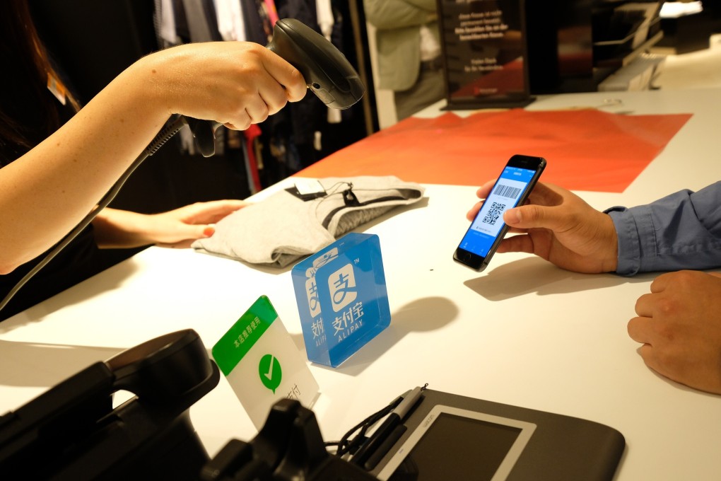 A customer using Alibaba's Alipay electronic payment service at the Breuninger store in Dusseldorf, Germany, on June 29, 2018. Photo: Xinhua