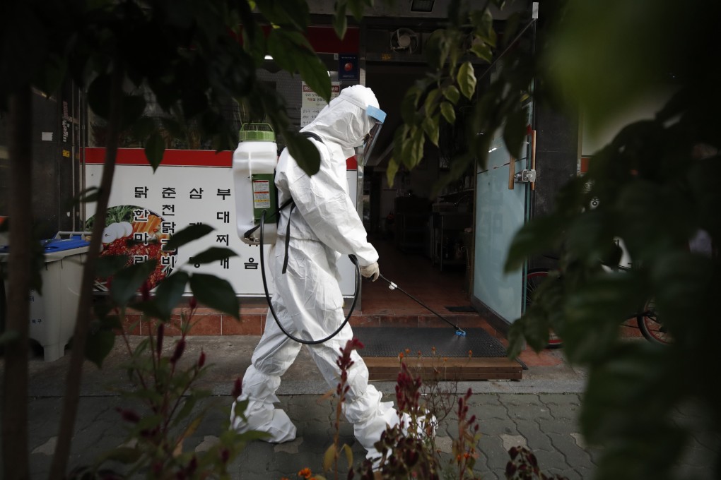 A South Korean health worker sprays disinfectant in Seoul. Photo: AP