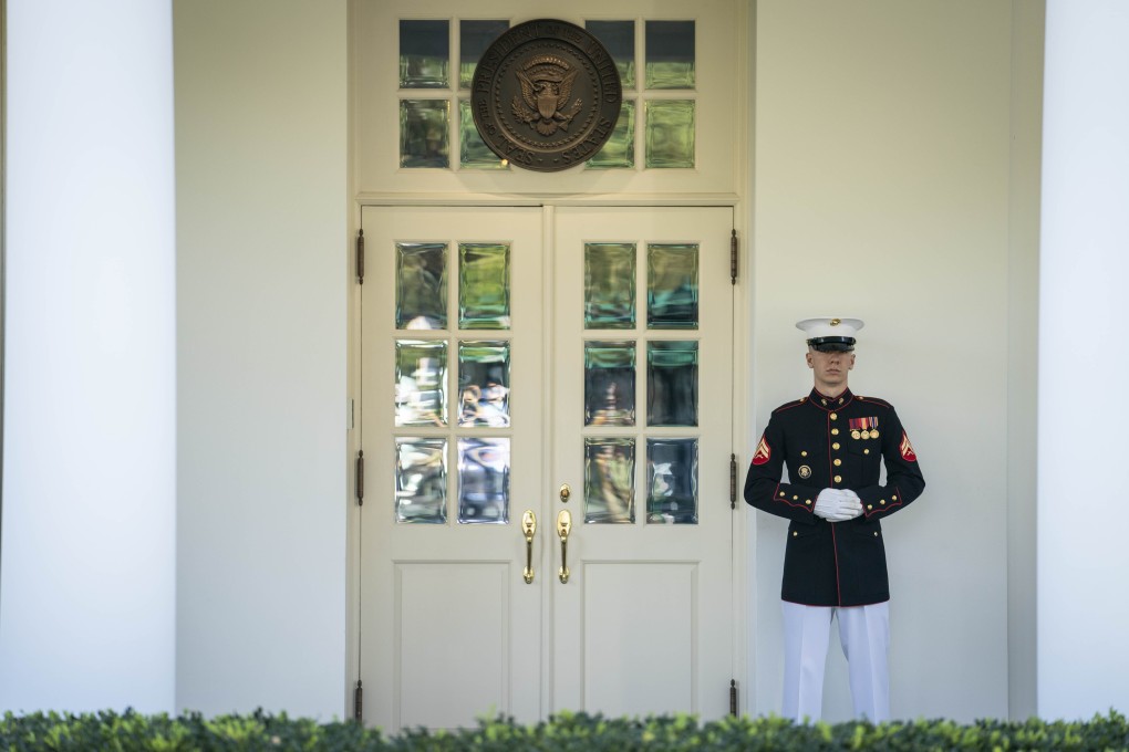 A member of the US Marines is posted at the West Wing door of the White House, an indication that President Donald Trump is in the Oval Office. Photo: Reuters