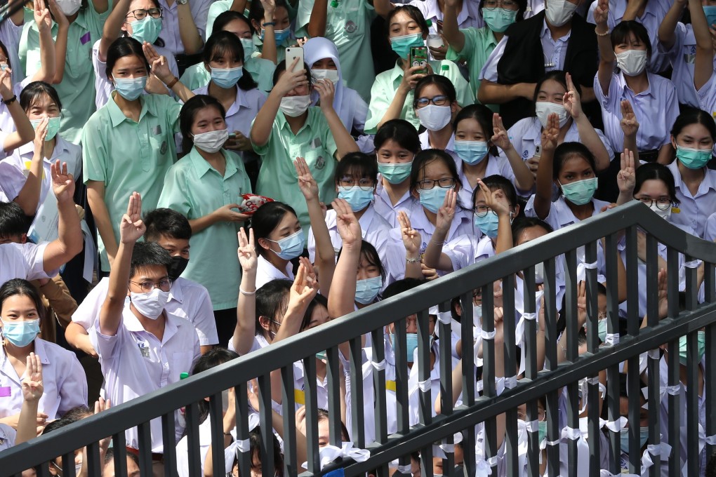 Thai students flash the three-finger salute during an anti-government protest at a school in Bangkok on October 2. Pupils are calling for an end to bullying and harassment in schools, and other education reforms. Photo: EPA-EFE