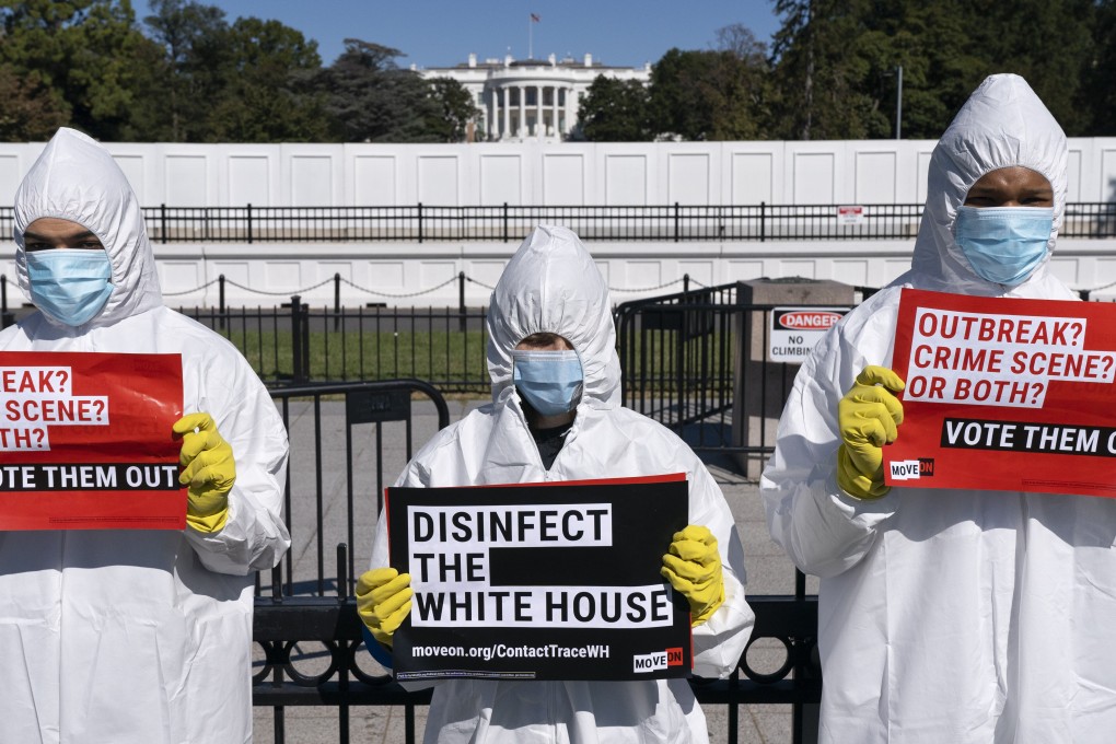 Wearing protective suits, masks and gloves, demonstrators call attention to the outbreak of coronavirus in the White House. Photo: AP