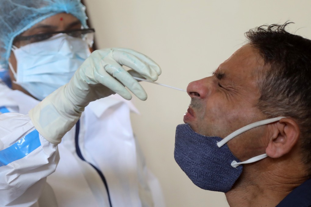 An Indian health worker collects swab samples during Covid-19 testing in Jammu. India has the second highest total of confirmed cases in the world. Photo: EPA-EFE
