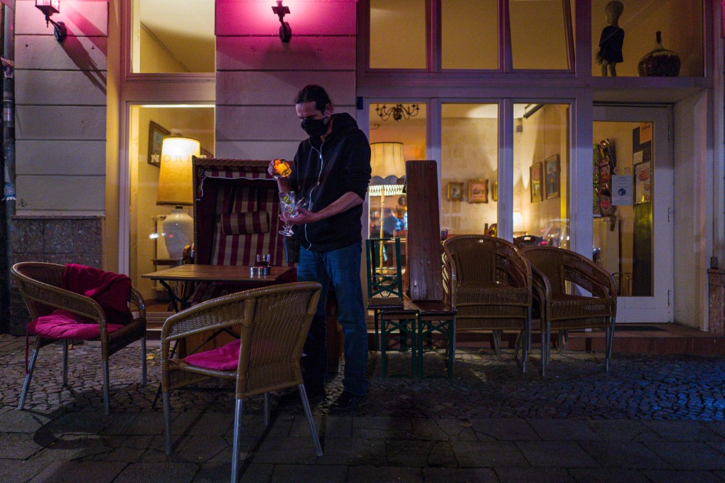A bar owner closes up early in Berlin's Prenzlauer Berg district on Saturday. Photo: AFP