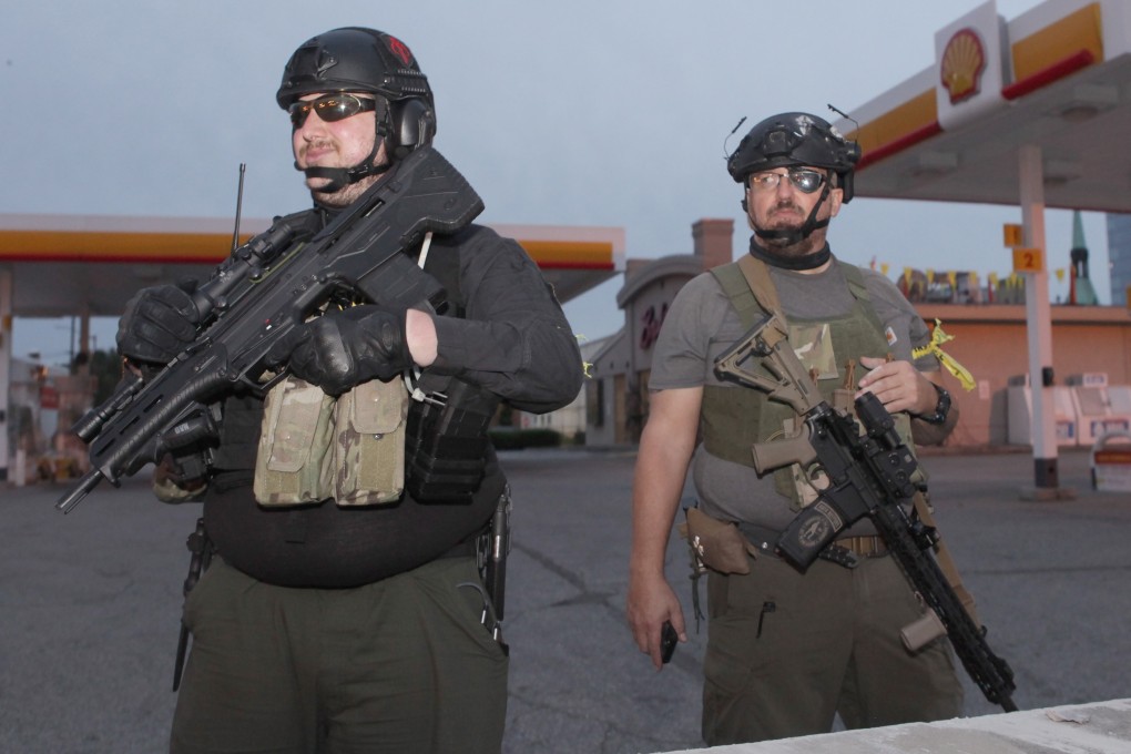 Two men who claim to be part of the Oath Keepers, which rejects militia, white supremacist and racist labels. Photo: EPA