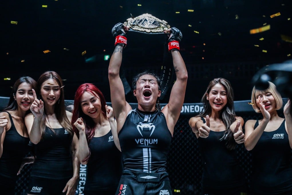 Angela Lee raises her atomweight title in the air after her ONE: Century win against Xiong Jingnan. Photos: ONE Championship