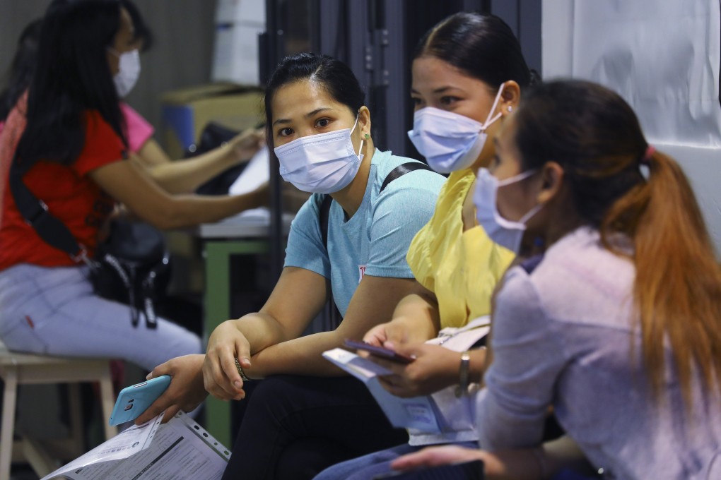 Overseas domestic workers at an employment agency in central Hong Kong. Domestic workers have reported increased workloads, stress levels and isolation since the beginning of the pandemic. Photo: SCMP