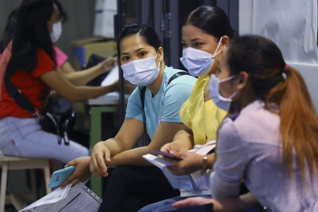 Overseas domestic workers at an employment agency in central Hong Kong. Domestic workers have reported increased workloads, stress levels and isolation since the beginning of the pandemic. Photo: SCMP