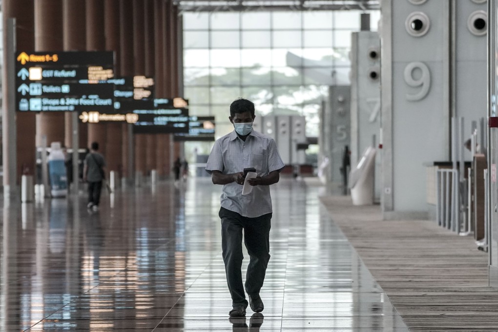 A man walks through the departure hall of the Changi Airport in Singapore. Photo: EPA