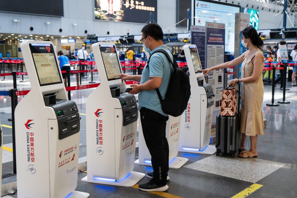 Travellers checking in at China Eastern Airlines' self check-in kiosks at Beijing Capital International Airport on Tuesday, August 25, 2020. Photo: Bloomberg