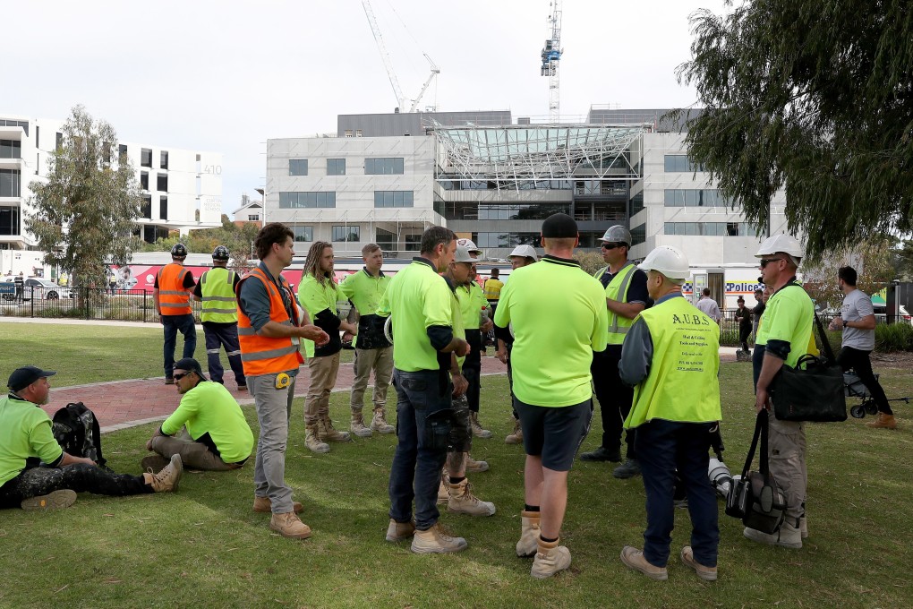Construction workers gather at the scene of a collapsed building at Curtin University in Perth, Australia. Photo: EPA