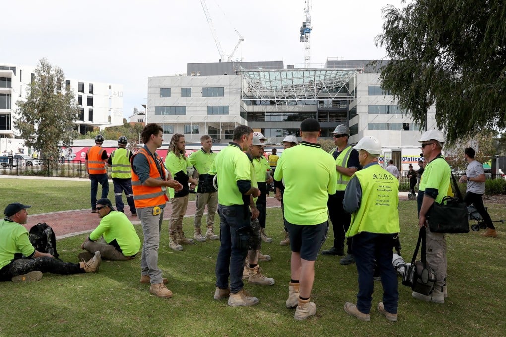 Construction workers gather at the scene of a collapsed building at Curtin University in Perth, Australia. Photo: EPA