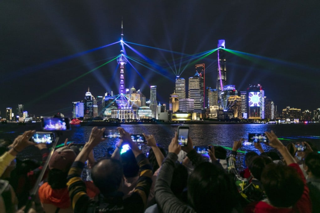 People enjoying a light show at the Bund in east China's Shanghai during the “golden week” holiday from October 1 to 8. Photo: Xinhua