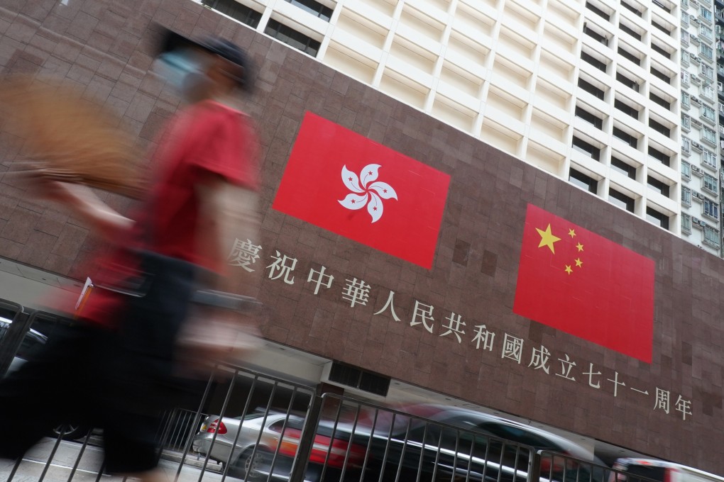 A pedestrian walks past the Chinese and Hong Kong flats at City Garden in North Point. Photo: Felix Wong