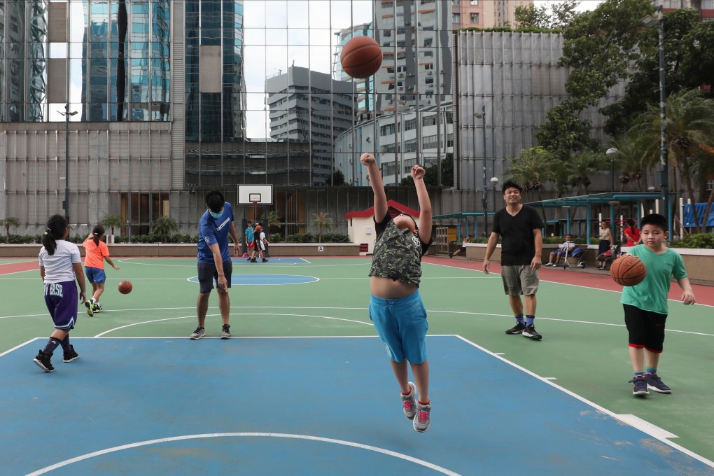 People play basketball at a public court in Quarry Bay on October 2, as gathering limits were relaxed for team sports at non-fee-charging outdoor leisure venues. Photo: Xiaomei Chen